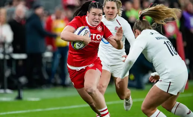 England's Zoe Harrison (10) moves to tackle Canada's Alysha Corrigan,left, who runs with the ball during the first half of a women's rugby match in Toronto, Friday, Oct. 16, 2026. (Arlyn McAdorey/The Canadian Press via AP)