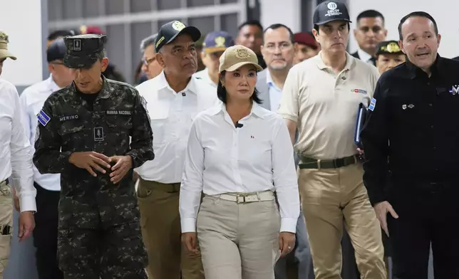 Peru's President Keiko Fujimori, center, tours the mega-prison known as the Terrorism Confinement Center (CECOT) in Tecoluca, El Salvador, Thursday, Oct. 29, 2026. (AP Photo/Salvador Melendez)