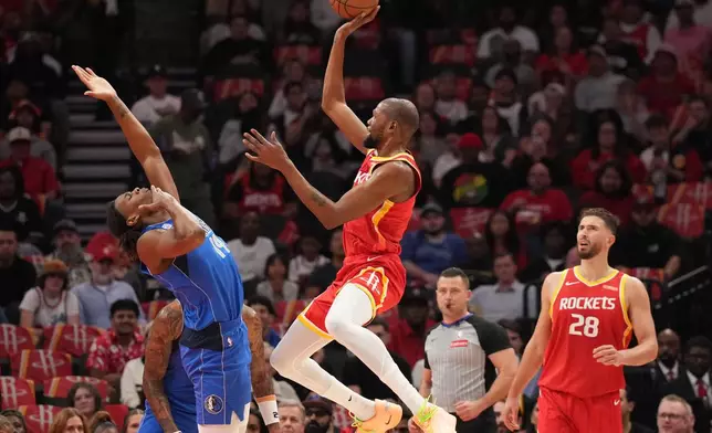 Houston Rockets forward Kevin Durant, center, shoots the ball over Dallas Mavericks forward Morez Johnson Jr., left, during the first half of an NBA basketball game, Wednesday, Oct. 21, 2026, in Houston. (AP Photo/Karen Warren)