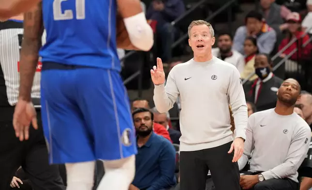 Dallas Mavericks head coach Dusty May reacts on the sidelines during the first half of an NBA basketball game against the Houston Rockets, Wednesday, Oct. 21, 2026, in Houston. (AP Photo/Karen Warren)