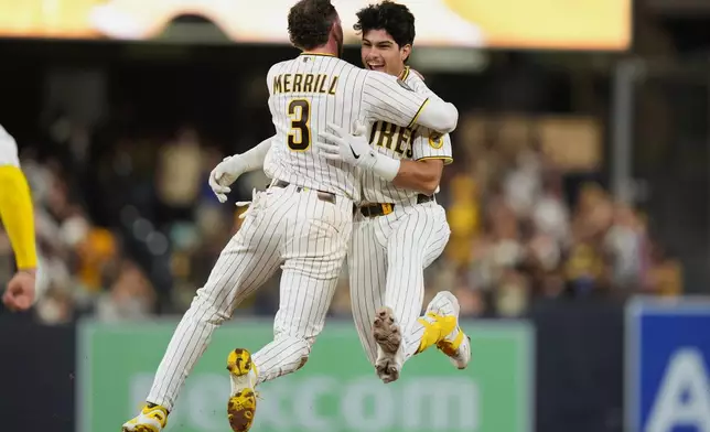 San Diego Padres' Ethan Salas, right, celebrates with teammate Jackson Merrill (3) after hitting a walk off single to defeat the Miami Marlins 7-6 during the tenth inning of a baseball game Saturday, Sept. 19, 2026, in San Diego. (AP Photo/Gregory Bull)