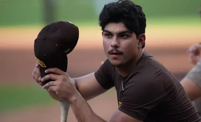 San Diego Padres catcher Ethan Salas looks on before Game 1 of the National League Wild Card baseball playoff series against the Chicago Cubs Tuesday, Sept. 29, 2026, in San Diego. (AP Photo/Gregory Bull)