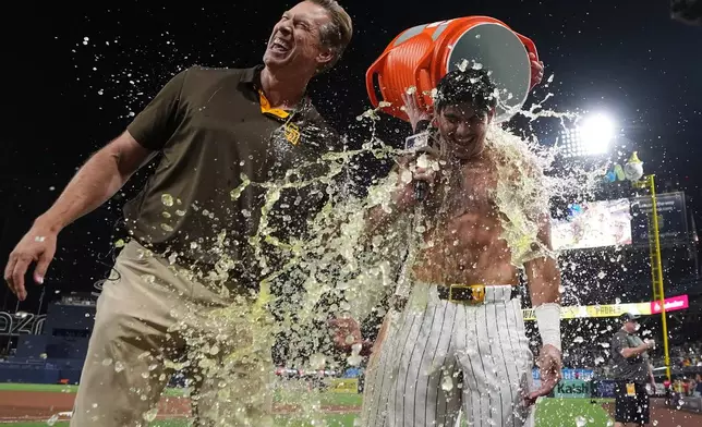 San Diego Padres' Ethan Salas, right, is doused after hitting a walk off single to defeat the Miami Marlins 7-6 during the tenth inning of a baseball game Saturday, Sept. 19, 2026, in San Diego. (AP Photo/Gregory Bull)