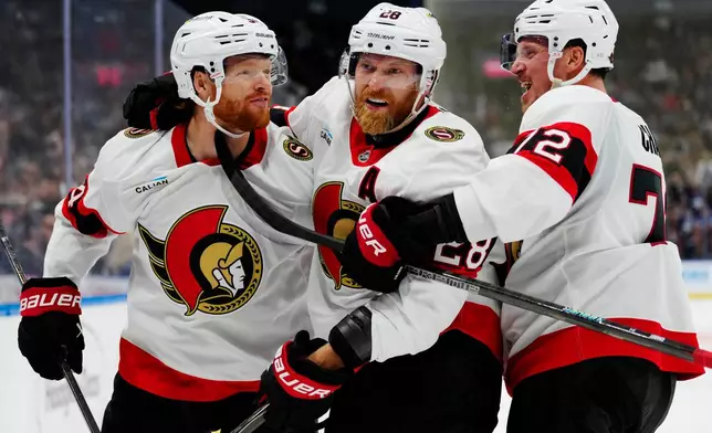 Ottawa Senators' Stephen Halliday, left, celebrates after his goal against the Toronto Maple Leafs with Claude Giroux (28) and Thomas Chabot (72) during the third period of an NHL hockey game in Toronto, Saturday, Oct. 3, 2026. (Frank Gunn/The Canadian Press via AP)