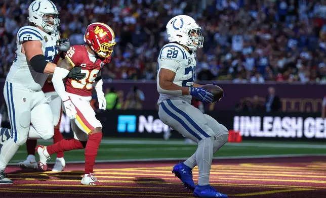 Indianapolis Colts running back Jonathan Taylor (28) celebrates after scoring his side's second touchdown during an NFL football game against Washington Commanders in London, Sunday, Oct. 4, 2026. (AP Photo/Ian Walton)