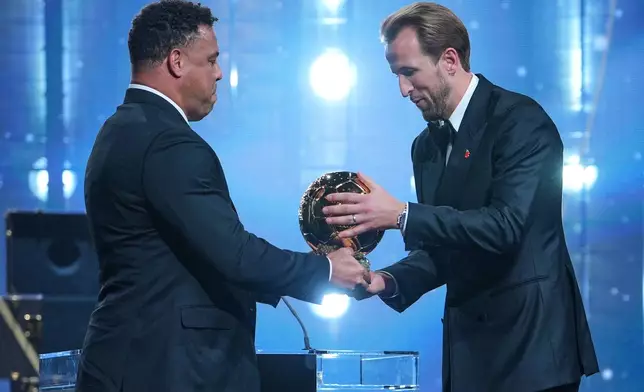 England's soccer player Harry Kane receives the player of the year trophy from Ronaldo Nazario during the Ballon d'Or ceremony at the London Palladium Theatre in London, England, Monday, Oct. 26, 2026 . (AP Photo/Kin Cheung)