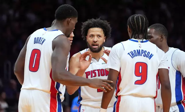 Detroit Pistons guard Cade Cunningham (2) talks with teammates during the first half of an NBA basketball game against the Miami Heat, Friday, Oct. 23, 2026, in Miami. (AP Photo/Rebecca Blackwell)
