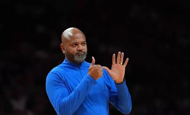 Detroit Pistons head coach J.B. Bickerstaff gestures during a time out in the first half of an NBA basketball game against the Miami Heat, Friday, Oct. 23, 2026, in Miami. (AP Photo/Rebecca Blackwell)