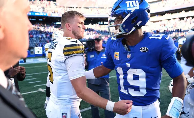 New Orleans Saints quarterback Tyler Shough (6) and New York Giants quarterback Jameis Winston (19) meet on the field after an NFL football game in East Rutherford, N.J., Sunday, Oct. 18, 2026. (AP Photo/Frank Franklin II)