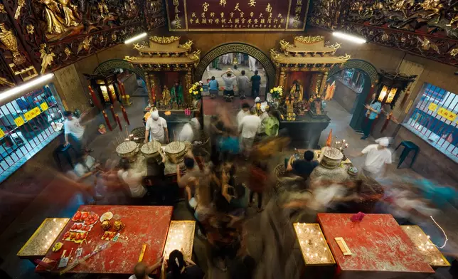Devotees offer incense and prayers at the Nine Emperor Gods Temple in Ampang, Selangor, Malaysia, Friday, Oct. 16, 2026. (AP Photo/Vincent Thian)