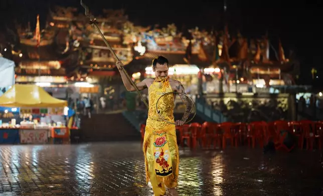A devout participates as a spirit medium during a spiritual purification procession for the Nine Emperor Gods Festival at Si Thian Kong Temple in Kuala Pilah, Malaysia, Wednesday, Oct. 14, 2026. (AP Photo/Vincent Thian)