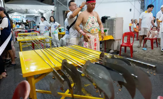 Devotees prepare to participate on the final day of the Nine Emperor Gods Festival on Penang island, Malaysia, Sunday, Oct. 18, 2026. (AP Photo/Vincent Thian)