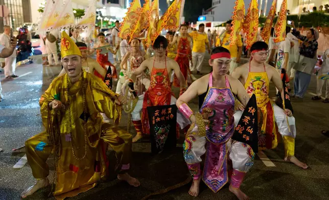 Devotees participating as spirit mediums perform rituals during a procession on the final day of the Nine Emperor Gods Festival on Penang island, Malaysia, Sunday, Oct. 18, 2026. (AP Photo/Vincent Thian)