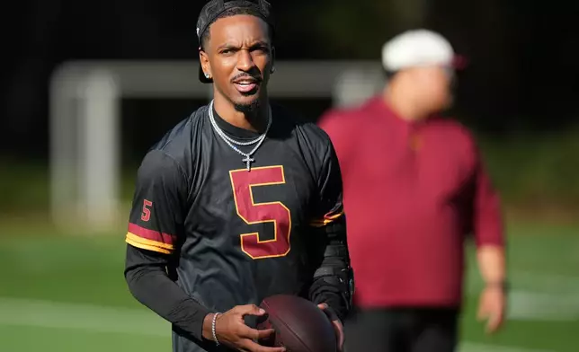 Washington Commanders quarterback Jayden Daniels (5), takes part in a NFL Football practice session in London, Wednesday, Sept. 30, 2026. (AP Photo/Alastair Grant)