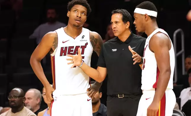 Miami Heat head coach Erik Spoelstra talks t0 forward Myron Gardner (15) and guard Ryan Conwell during the second half of an NBA preseason basketball game against the Minnesota Timberwolves Saturday, Oct. 10, 2026, in Miami. (AP Photo/Marta Lavandier)