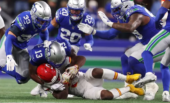 Kansas City Chiefs running back Kenneth Walker II is brought down by Seattle Seahawks linebacker Ernest Jones IV (13) during the second half of an NFL football game in Seattle, Sunday, Oct. 25, 2026. (AP Photo/Kevin Ng)