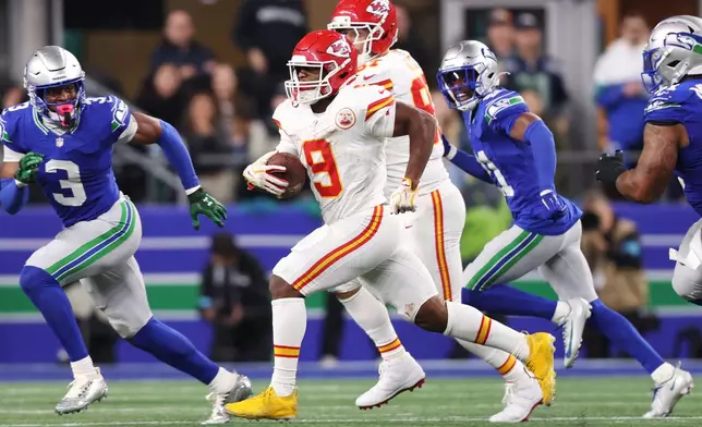 Kansas City Chiefs running back Kenneth Walker III (9) runs the ball during the second half of an NFL football game against the Seattle Seahawks in Seattle, Sunday, Oct. 25, 2026. (AP Photo/Kevin Ng)