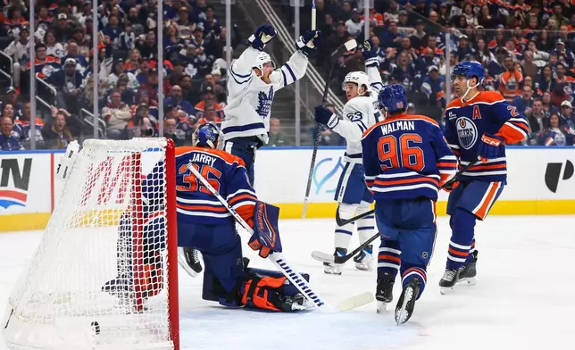 Toronto Maple Leafs' Jack Roslovic, back left, and Easton Cowan (53) celebrate after Roslovic's goal against the Edmonton Oilers during the first period of an NHL hockey game in Edmonton, Alberta, Saturday, Oct. 24, 2026. (Codie McLachlan/The Canadian Press via AP)