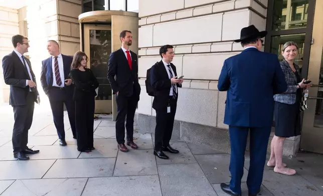 People wait line outside the Federal Courthouse, Monday, October.19, 2026, in Washington, before the start of a hearing in the lawsuit challenging the President Donald Trump administration's tree removal and redevelopment plans at East Potomac Golf Links, Monday, Oct. 19, 2026, in Washington. (AP Photo/Manuel Balce Ceneta)