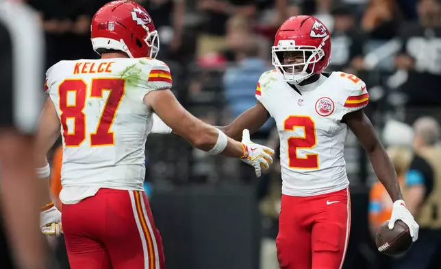 Kansas City Chiefs wide receiver Tyquan Thornton (2) is congratulated by tight end Travis Kelce (87) after scoring a touchdown during the second half of an NFL football game against the Las Vegas Raiders in Las Vegas, Sunday, Oct. 4, 2026. (AP Photo/John Locher)