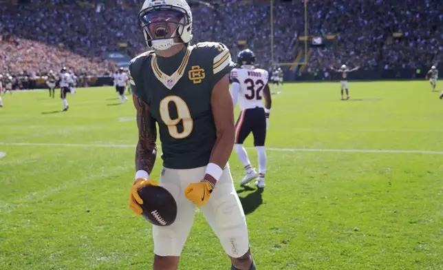 Green Bay Packers' Christian Watson celebrates after catching a touchdown pass during the first half of an NFL football game against the Chicago Bears in Green Bay, Wis., Sunday, Oct. 11, 2026. (AP Photo/Mike Roemer)
