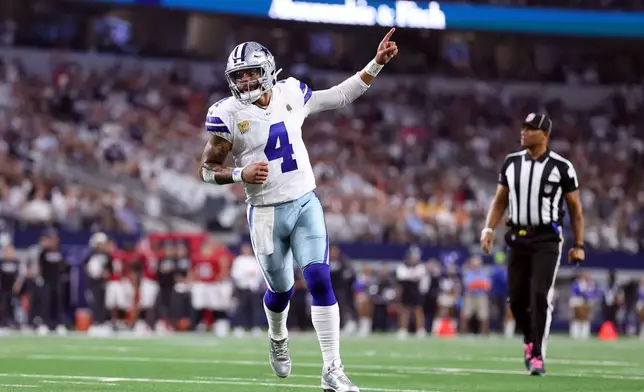 Dallas Cowboys quarterback Dak Prescott celebrates as teammate Javonte Williams scores a touchdown against the Tampa Bay Buccaneers in the first half of an NFL football game in Arlington, Texas on Thursday, Oct. 8, 2026. (AP Photo/Sam Hodde)