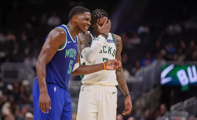 Minnesota Timberwolves' guard Anthony Edwards, right, and Milwaukee Bucks' guard Kevin Porter Jr., right, react during a preseason NBA basketball game Monday, Oct. 5, 2026, in Milwaukee. (AP Photo/Kylie Bridenhagen)