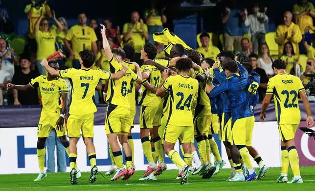 Villarreal players celebrate at the end of the Champions League opening phase soccer match between Villarreal and Napoli, in Villarreal, Spain, Tuesday, Oct. 13, 2026. (AP Photo/Alberto Saiz)