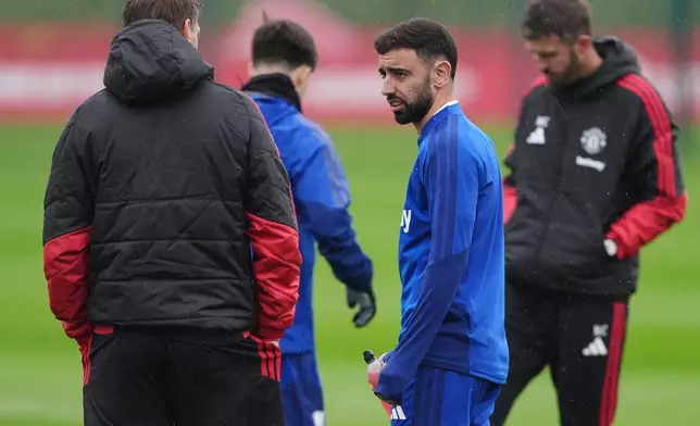Manchester United Bruno Fernandes, second right, attends a training session in Manchester, England, Tuesday Oct. 20, 2026. (Martin Rickett/PA via AP)