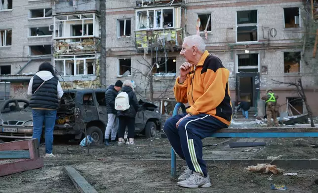 An elderly man sits on the bench in front of building damaged by a Russian strike on residential neighbourhood in Zaporizhzhia, Ukraine, Friday, Oct. 9, 2026. (AP Photo/Kateryna Klochko)