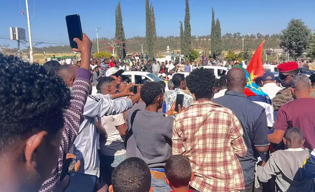 In this photo taken with a smartphone, supporters gather to welcome former Tigray leader Getachew Reda in Mekelle, Ethiopia, Sunday, Oct. 11, 2026. (AP Photo/Filmon Equar Hailu)