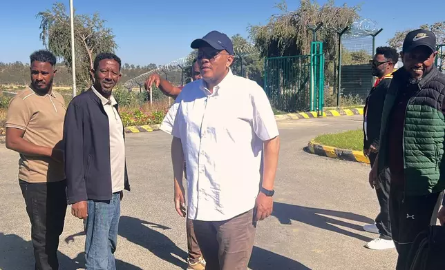 In this photo taken with a smartphone Getachew Reda, center, a former Tigray leader and adviser to Ethiopian Prime Minister Abiy Ahmed, arrives at the airport in Mekelle, Ethiopia, Sunday, Oct. 11, 2026. (AP Photo/Filmon Equar Hailu)