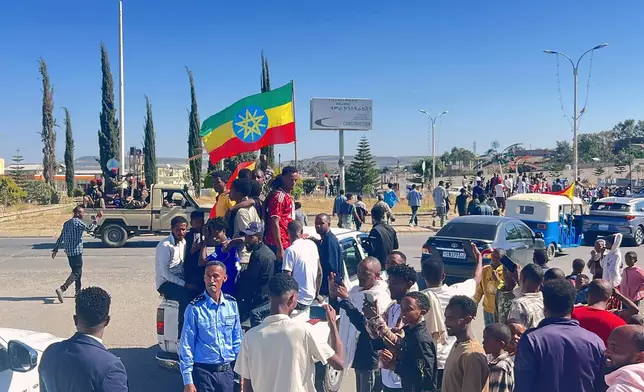 In this photo taken with a smartphone, supporters gather to welcome former Tigray leader Getachew Reda in Mekelle, Ethiopia, Sunday, Oct. 11, 2026. (AP Photo/Filmon Equar Hailu)