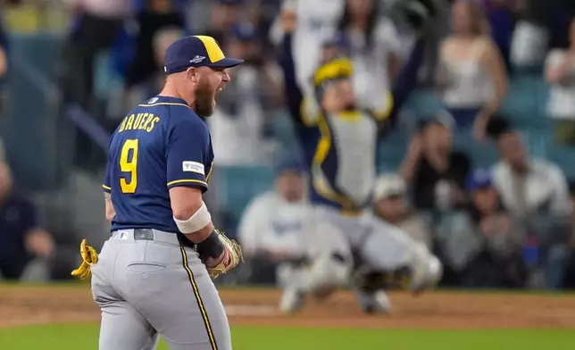 Milwaukee Brewers first baseman Jake Bauers (9) celebrates after Game 4 of baseball's National League Championship Series between the Milwaukee Brewers and the Los Angeles Dodgers, Thursday, Oct. 15, 2026, in Los Angeles. (AP Photo/Mark J. Terrill)