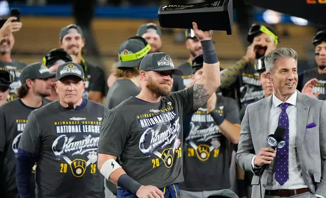 Milwaukee Brewers first baseman Jake Bauers hols the NLCS MVP trophy after Game 4 of baseball's National League Championship Series between the Milwaukee Brewers and the Los Angeles Dodgers, Thursday, Oct. 15, 2026, in Los Angeles. (AP Photo/Ashley Landis)