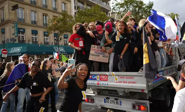 Students chant during a march to protest against under-resourced schools in Paris, Tuesday Oct. 13, 2026. (AP Photo/Thibault Camus)