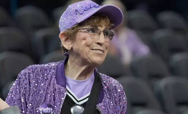 Golden State Valkyries fan Cynthia Cheak smiles as she hands out wristbands to fans before an WNBA basketball game between the Valkyries and Seattle Storm in San Francisco, Sept. 19, 2026. (AP Photo/Jeff Chiu)