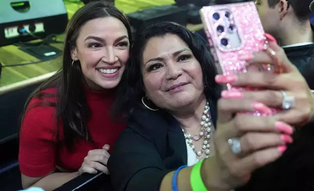 Rep. Alexandria Ocasio-Cortez, left, D-N.Y., poses for a photo with a supporter during a campaign rally for Randy Villegas, Democratic candidate for congress in California's 22nd District, Friday, Oct. 23, 2026, in Bakersfield, Calif. (AP Photo/Jae C. Hong)