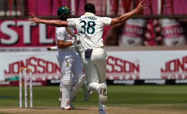 Australia's Josh Hazlewood celebrates after dismissing South Africa's Wiaan Mulder on day five of the first cricket test match between South Africa and Australia, in Durban, South Africa, Tuesday, Oct. 13, 2026. (AP Photo/Themba Hadebe)