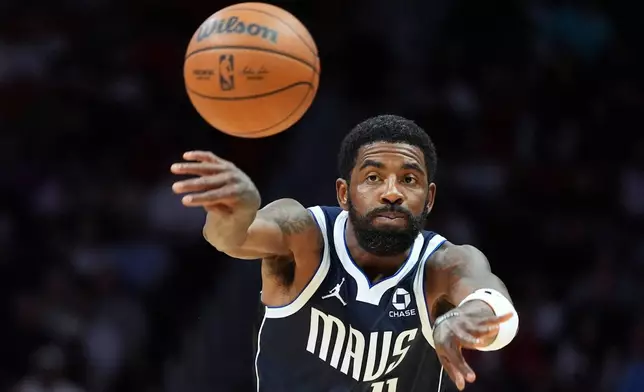 Dallas Mavericks guard Kyrie Irving (11) passes the ball during the first half of an NBA basketball game against the Miami Heat, Monday, Oct. 26, 2026, in Miami. (AP Photo/Rebecca Blackwell)