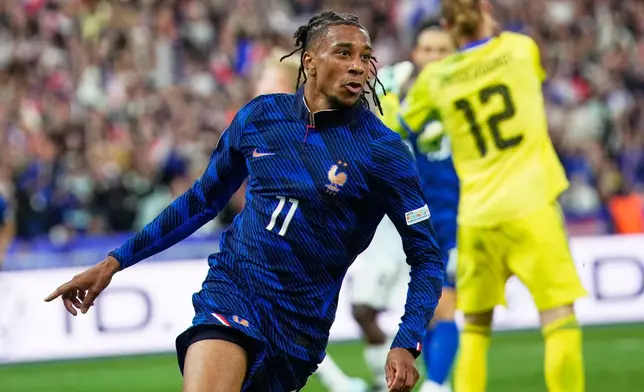 France's Michael Olise celebrates after scoring during the Nations League soccer match between France and Belgium in Saint-Denis near Paris, Monday, Oct. 5, 2026. (AP Photo/Teresa Suarez)