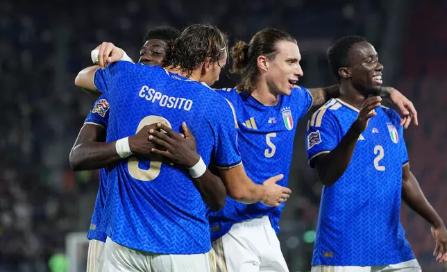 Italy's Pio Esposito, second from left, celebrates with teammates after scoring his side's third goal during the UEFA Nations League soccer match between Italy and Turkey in Bologna, Italy, Monday, Oct. 5, 2026. (AP Photo/Antonio Calanni)