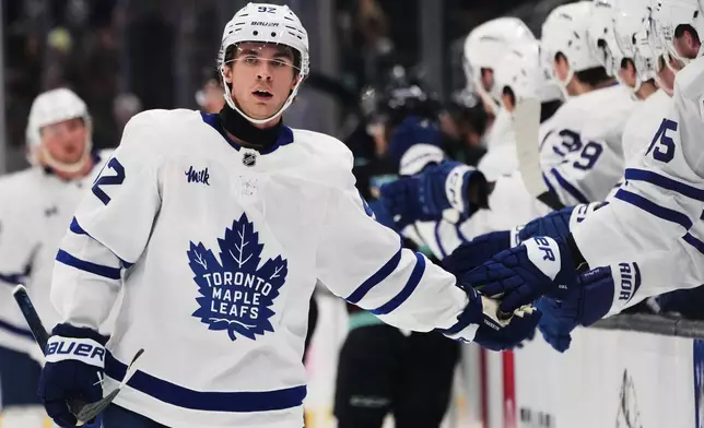 Toronto Maple Leafs left wing Gavin McKenna celebrates his goal against the Seattle Kraken with the bench during the first period of an NHL hockey game, Wednesday, Oct. 28, 2026, in Seattle. (AP Photo/Lindsey Wasson)