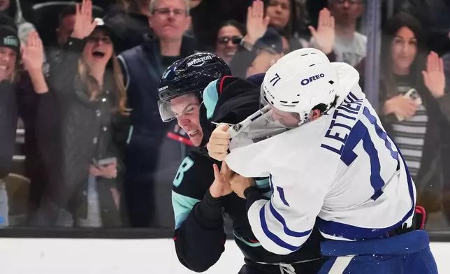 Seattle Kraken defenseman Cale Fleury, left, fights with Toronto Maple Leafs center Vinni Lettieri, right, during the second period of an NHL hockey game, Wednesday, Oct. 28, 2026, in Seattle. (AP Photo/Lindsey Wasson)