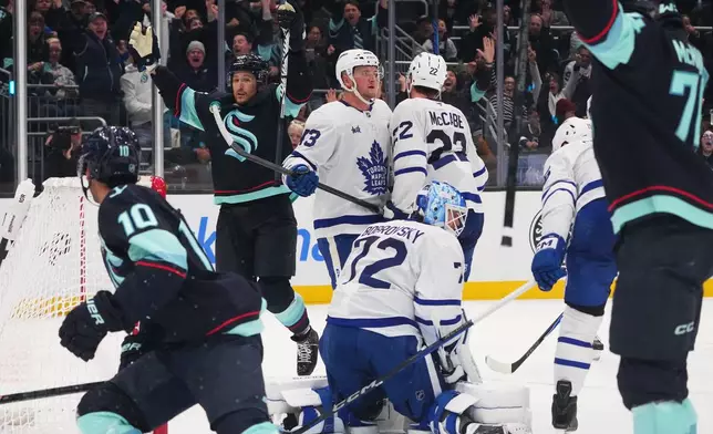 Seattle Kraken defenseman Brandon Montour, second from left, celebrates after making the game-winning goal late during the third period of an NHL hockey game against Toronto Maple Leafs goaltender Sergei Bobrovsky (72), Wednesday, Oct. 28, 2026, in Seattle. (AP Photo/Lindsey Wasson)