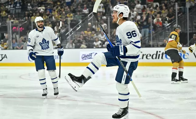 Toronto Maple Leafs' Jack Roslovic (96) reacts after scoring against the Vegas Golden Knights during the first period of an NHL hockey game Thursday, Oct. 8, 2026, in Las Vegas. (AP Photo/David Becker)