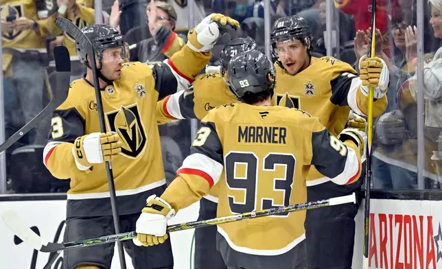 Vegas Golden Knights' Brett Howden, right, celebrates with teammates after a goal against the Toronto Maple Leafs during the second period of an NHL hockey game Thursday, Oct. 8, 2026, in Las Vegas. (AP Photo/David Becker)