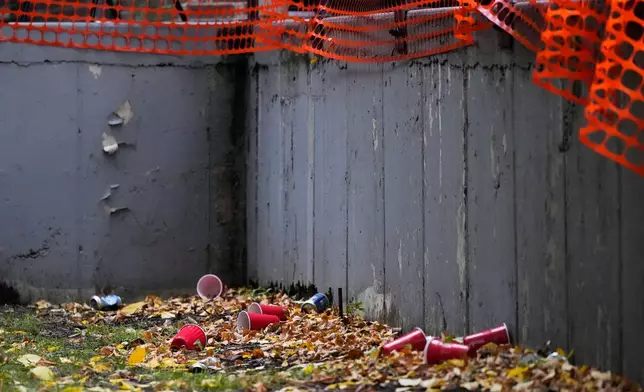 Cups and cans are seen outside the AEPi fraternity house near the University of Chicago campus in Chicago, Wednesday, Oct. 14, 2026, where an alleged sexual assault was reported at a weekend party. (AP Photo/Nam Y. Huh)