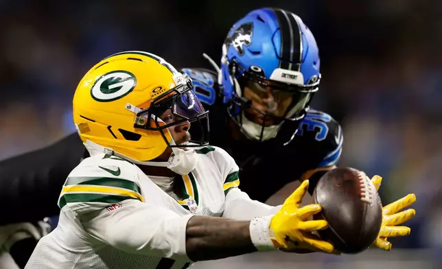 Green Bay Packers wide receiver Matthew Golden reaches for an incomplete pass ahead of Detroit Lions cornerback Khalil Dorsey (30) during the second half of an NFL football game, Sunday, Oct. 25, 2026, in Detroit. (AP Photo/Rey Del Rio)