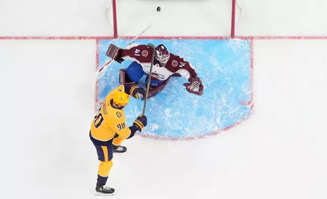 Nashville Predators center Ryan O'Reilly (90) celebrates a goal scored by left wing Filip Forsberg past Colorado Avalanche goaltender Scott Wedgewood (41) during the first period of an NHL hockey game Sunday, Oct. 25, 2026, in Nashville, Tenn. (AP Photo/George Walker IV)